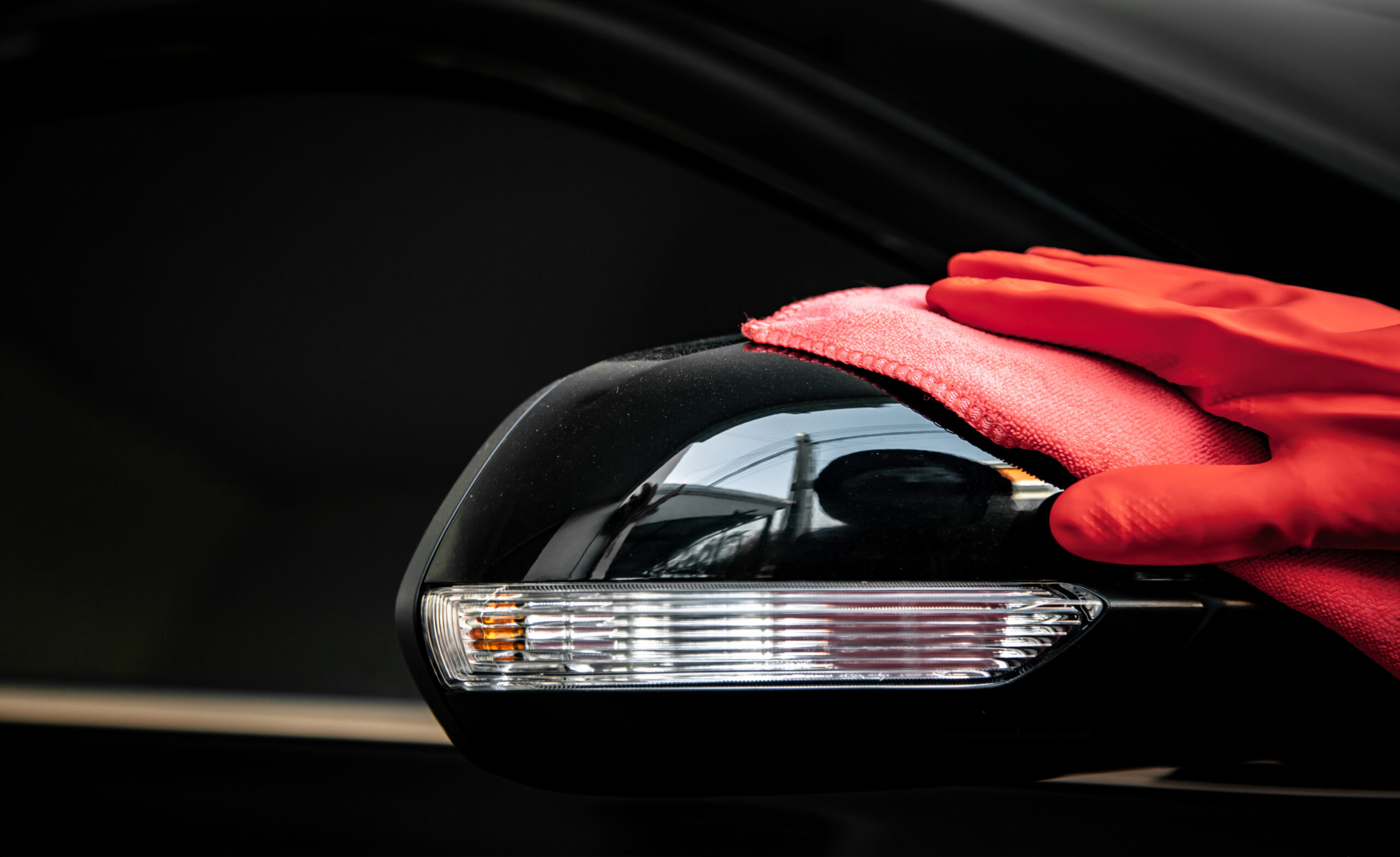 Car wash cleaning concepts . Auto service staff cleaning car with microfiber cloth in Interior car console